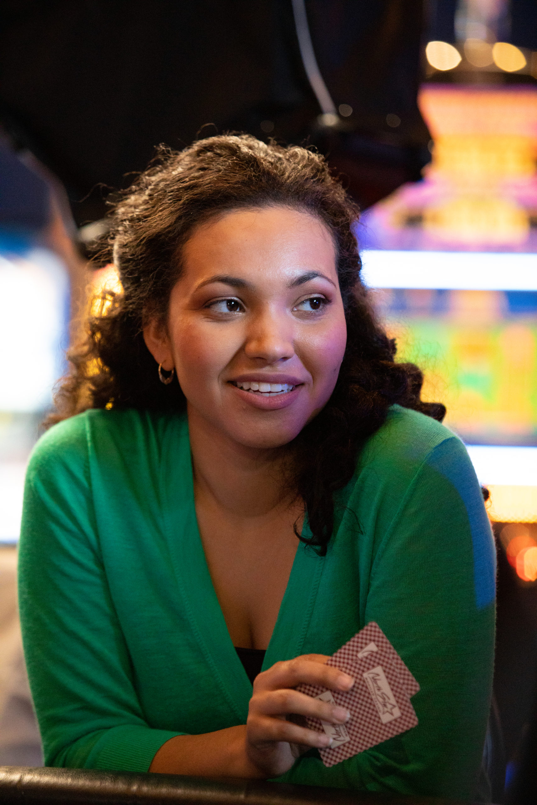 woman smiling with two cards in her hand