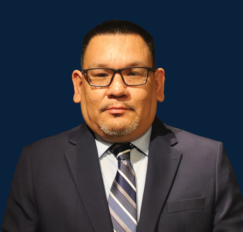 Executive Host Bernard Tourtillott with a blue background